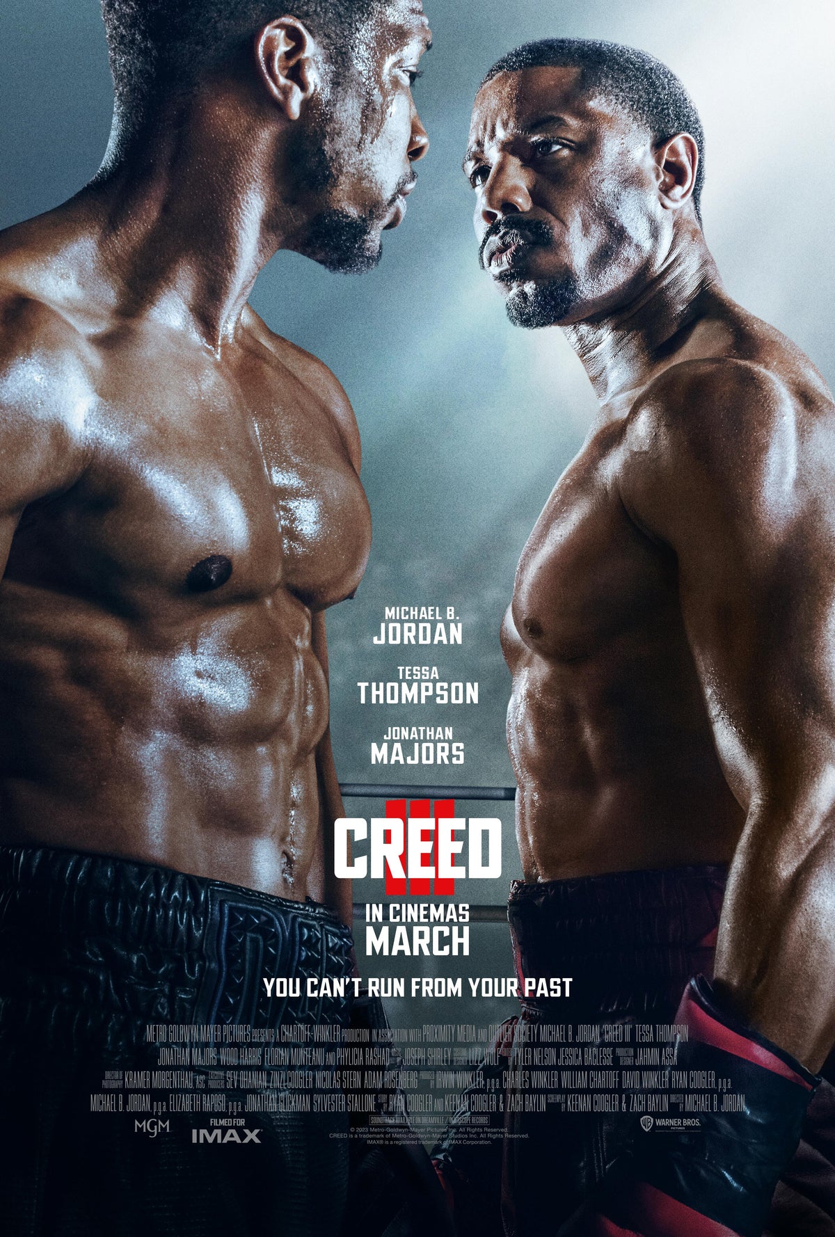 Promotional poster for Creed III showing Adonis Creed and Damian Anderson standing face to face locked in an intense staring contest.