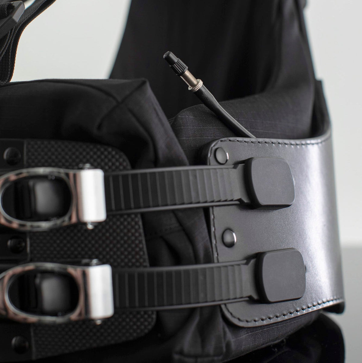 Air bladder tube peaking out from the side of a Flex Harness, showing the capped nozzle