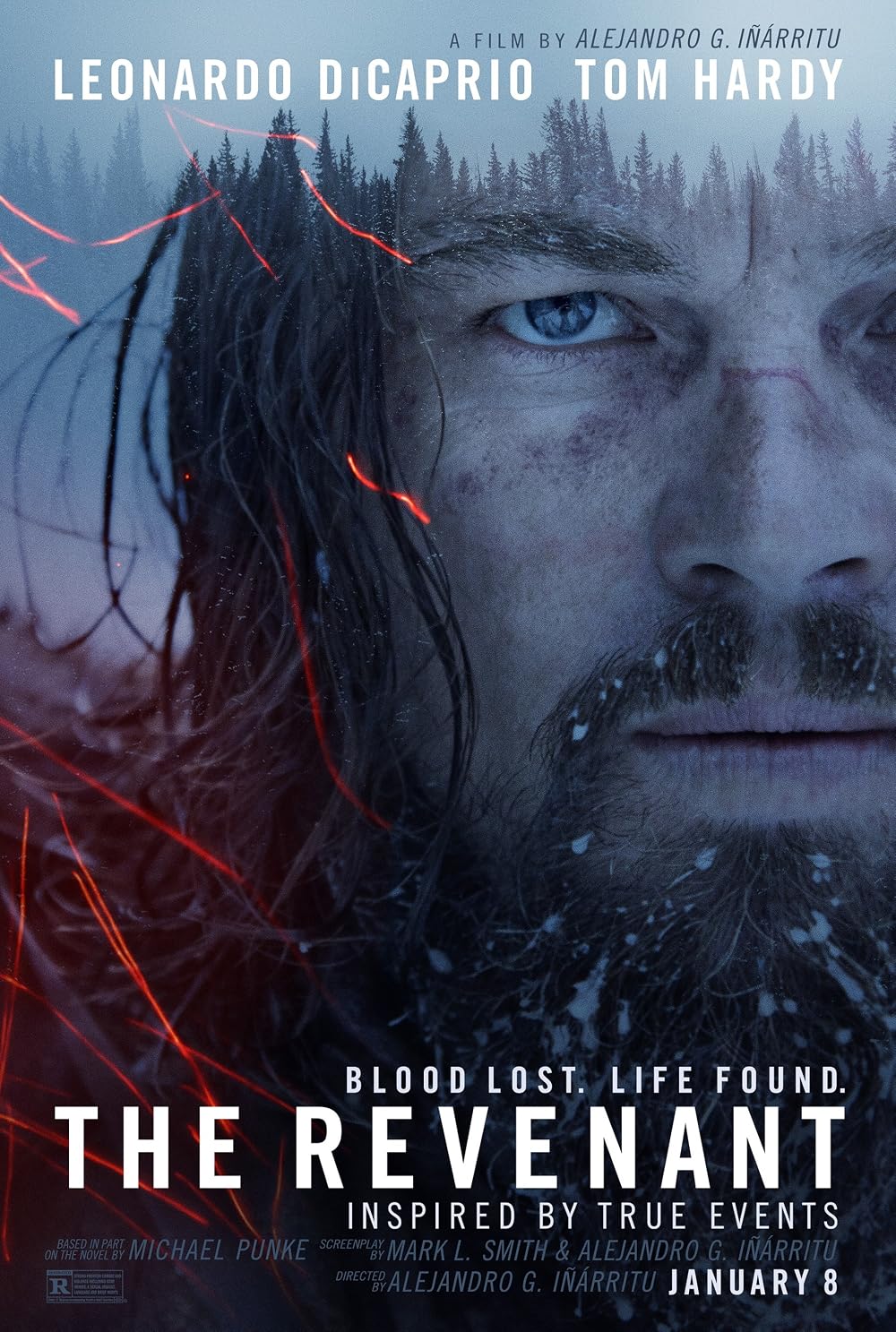 Promotional poster for 'The Revenant' featuring a front view of a rugged, heavily bearded Leonardo DiCaprio as Hugh Glass. He stares intensely into the distance with a grim, fierce expression. Snowflakes and ice are frozen into his long hair and beard. 