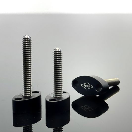 Three thumb screws, two standing up to show off the difference in size between the 1.25 inch and 1.5 inch lengths and the third showing off the laser etched Walter Klassen FX logo on the screw's head