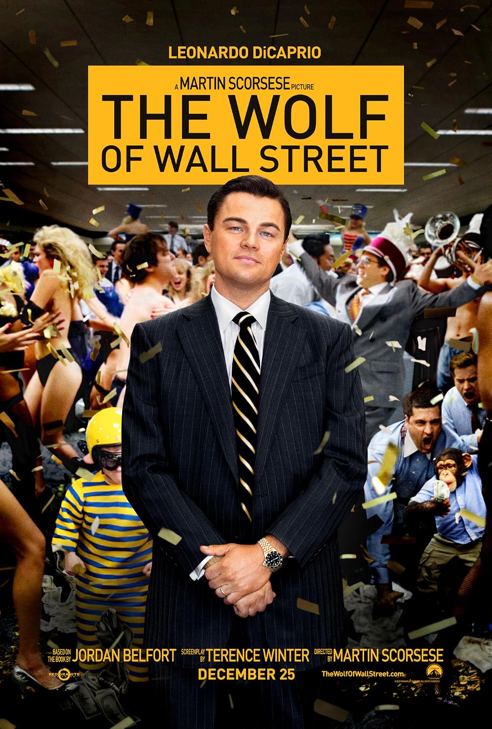 Promotional poster for 'The Wolf Of Wall Street' Leonardo DiCaprio as Jordan Belfort stands confidently in the foreground, wearing a black suit, a pinstripe tie, and a smirking expression. He stands in front of a chaotic, high-energy stock brokerage office scene behind him. In the background, dozens of ecstatic people are cheering, throwing confetti into the air